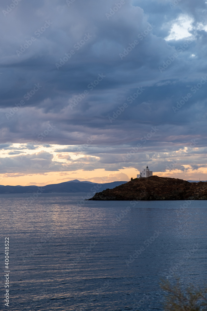 Greece, Kea Tzia island. Lighthouse on rocky cape, sky, sea background.