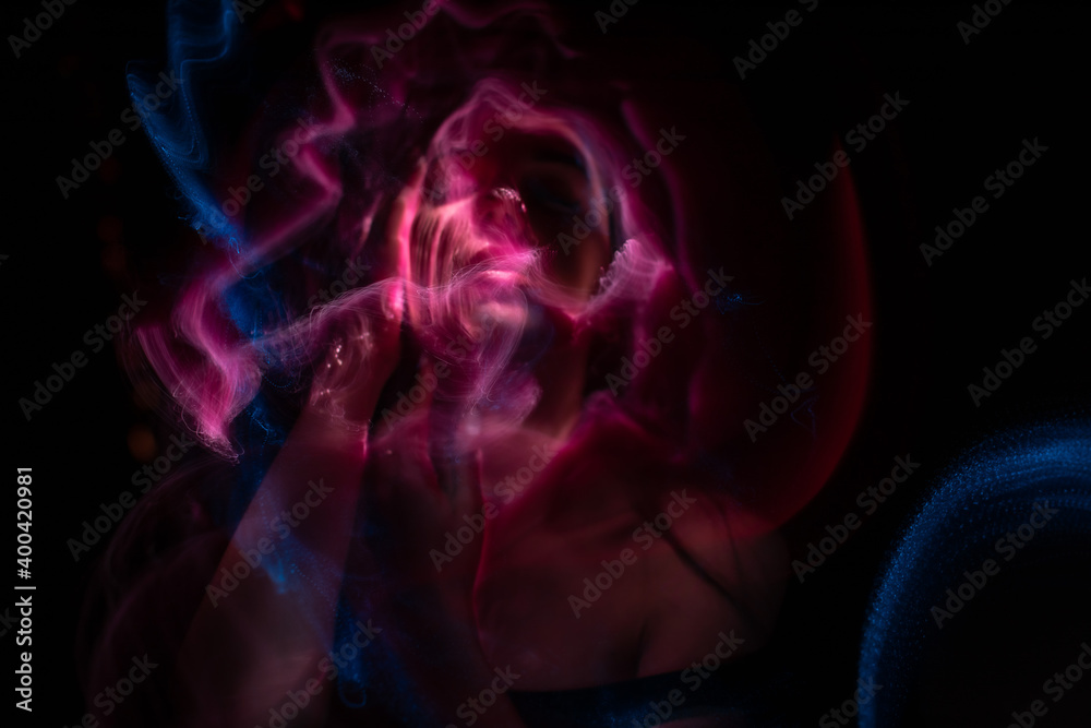 Girl, model photographed on a long exposure in the studio with color filters. Portrait Girl, model photographed on a long exposure in the studio with color filters. Portrait