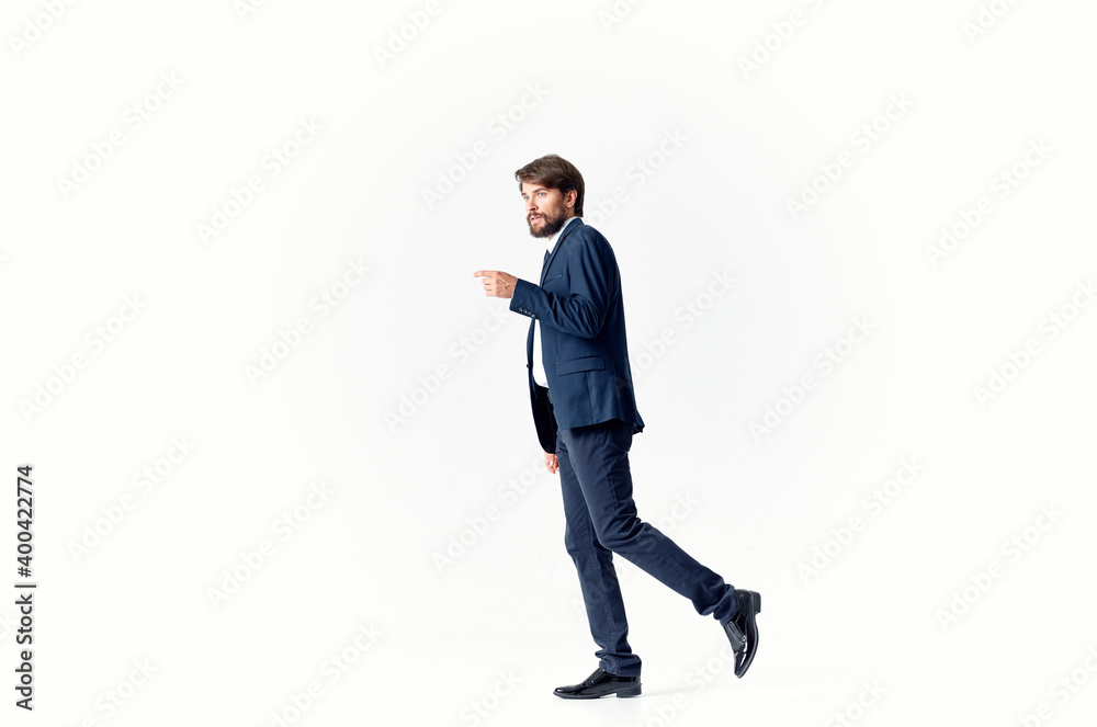 business man in a suit and shoes walks to the side on a light background Copy Space business man in a suit and shoes walks to the side on a light background Copy Space
