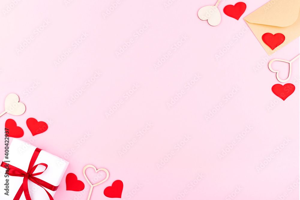 Background with gifts, envelope, hearts with free space for text on pastel pink background. Flat lay, top view. Valentines day concept. Mother's Day concept.