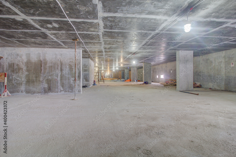 Underground parking in construction phase. Empty garage in basement of