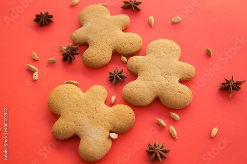 gingerbread in the form of ginger men on a red background, New Year and Christmas photo. 