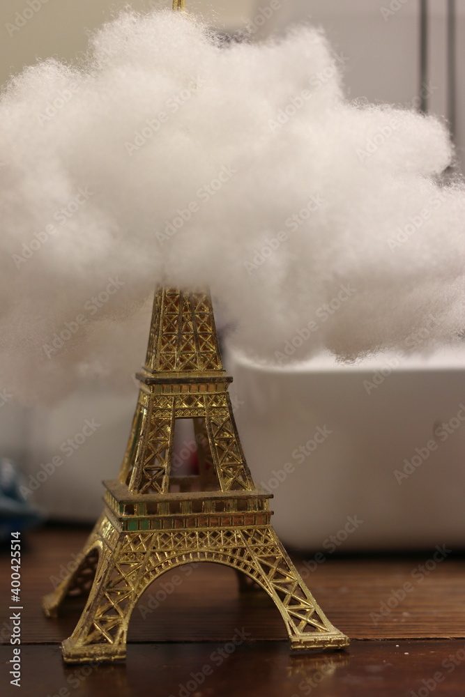 Gold Eiffel Tower with clouds on desk