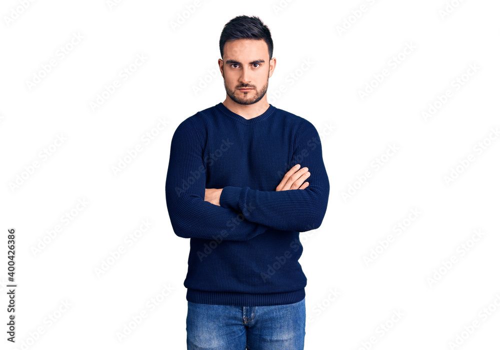 Young handsome man wearing casual clothes skeptic and nervous, disapproving expression on face with crossed arms. negative person. Young handsome man wearing casual clothes skeptic and nervous, disapproving expression on face with crossed arms. negative person.