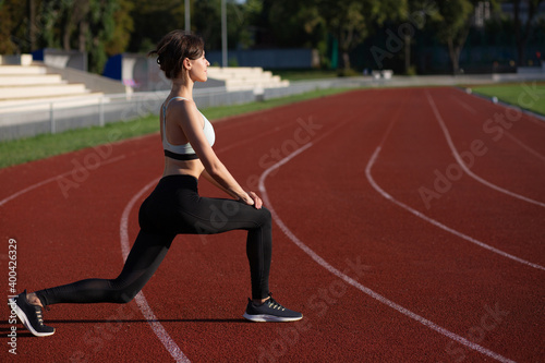 Fit young woman doing lunges