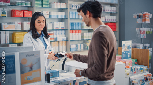 Obraz na plátně Pharmacy Drugstore Checkout Cashier Counter: Beautiful Female Pharmacist and Han