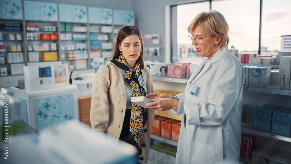 Pharmacy Drugstore: Beautiful Young Woman Chooses to Buy Medicine, Drugs, Vitamins, Professional Pharmacist Helping with Advice. Customers Support in Store with Shelves Full of Health Care Products