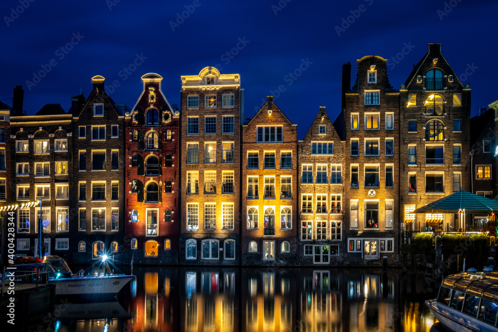 Damrak and buildings of Amsterdam by night, long exposure