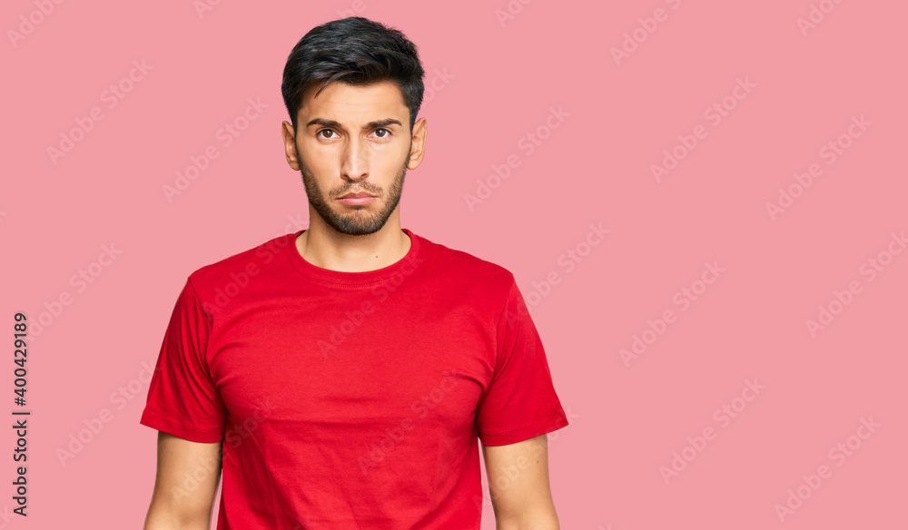 Obraz premium Young handsome man wearing casual red tshirt depressed and worry for distress, crying angry and afraid. sad expression.