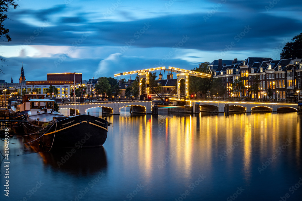 blue hour in Amsterdam, skinny bridge, Amstel river and opera house