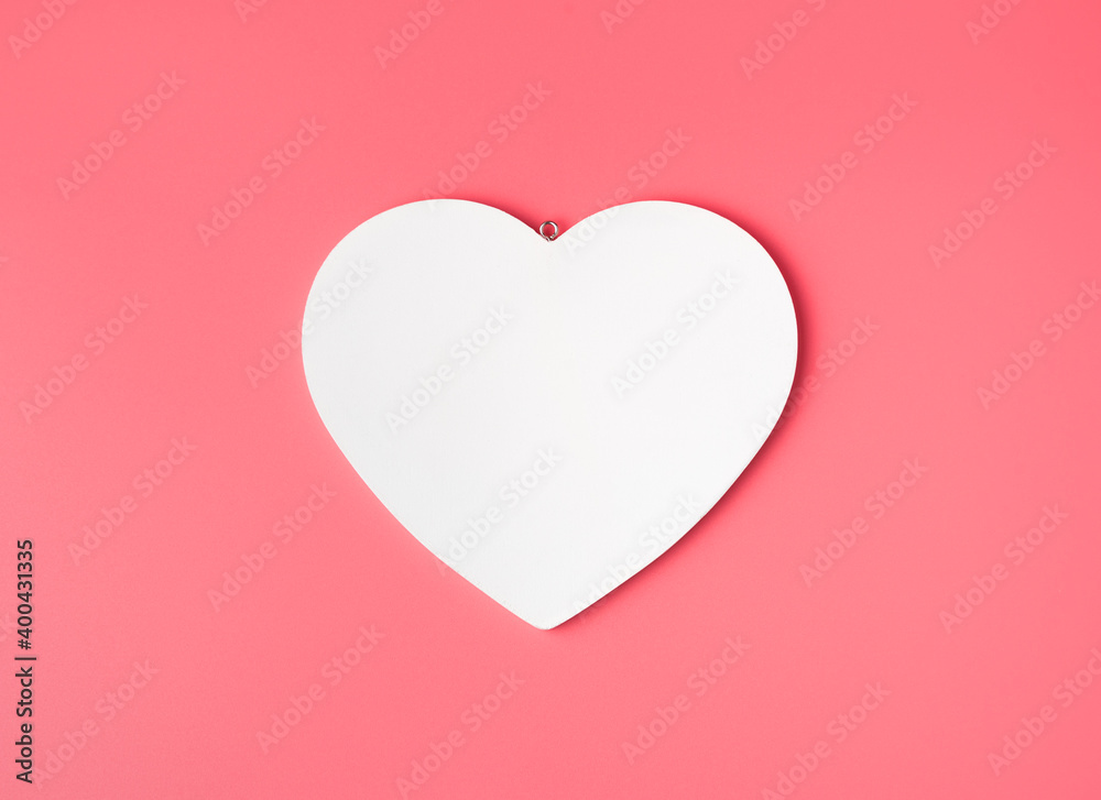 The heart is white on a delicate light pink background. Top view with space to copy. concept february 14.