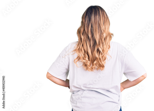 Young caucasian woman wearing casual clothes standing backwards looking away with arms on body