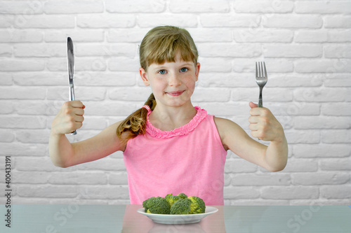 kid child ikes eating broccoli photo