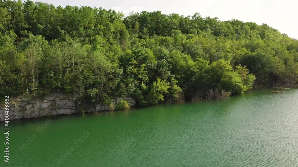 Beautiful azure lake with a rocky, steep bank, rising drone. Aerial view on a blue lake. Amazing beauty of nature. Beautiful summer landscape with water Beautiful azure lake with a rocky, steep bank, rising drone. Aerial view on a blue lake. Amazing beauty of nature. Beautiful summer landscape with water