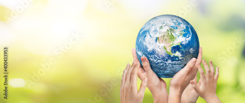 Earth globe in family hands. World environment day