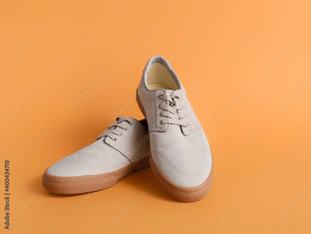 Casual male shoes on color background