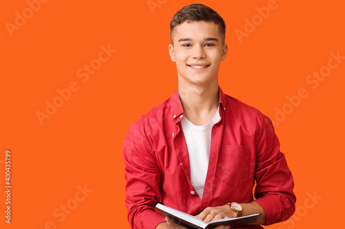 Teenage boy with book on co...