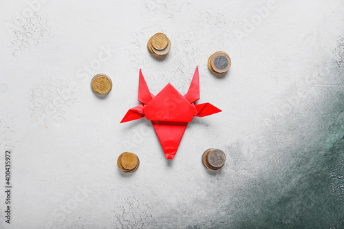 Money and origami bull on g...