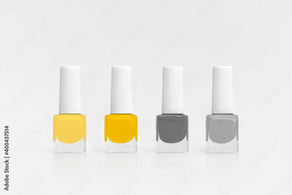 Nail polish isolated on white background. Colors of the year 2021 - Illuminating and Ultimate Grey. Nail polish isolated on white background. Colors of the year 2021 - Illuminating and Ultimate Grey.