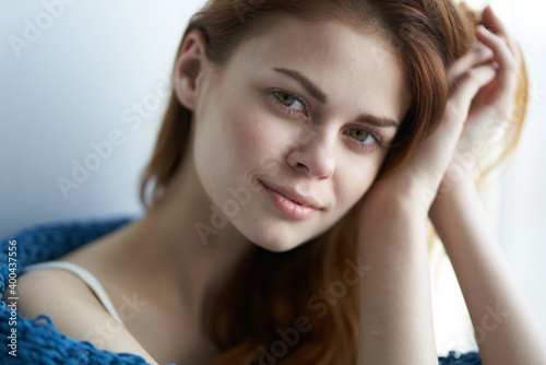 woman pretty woman sitting near the window covered by a plaid charm comfort