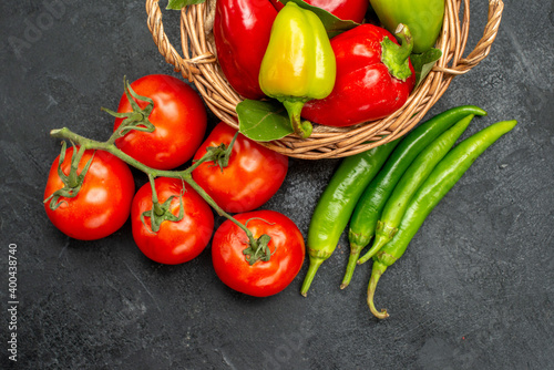 top view fresh bell-peppers with red tomatoes on dark background food salad ripe photos