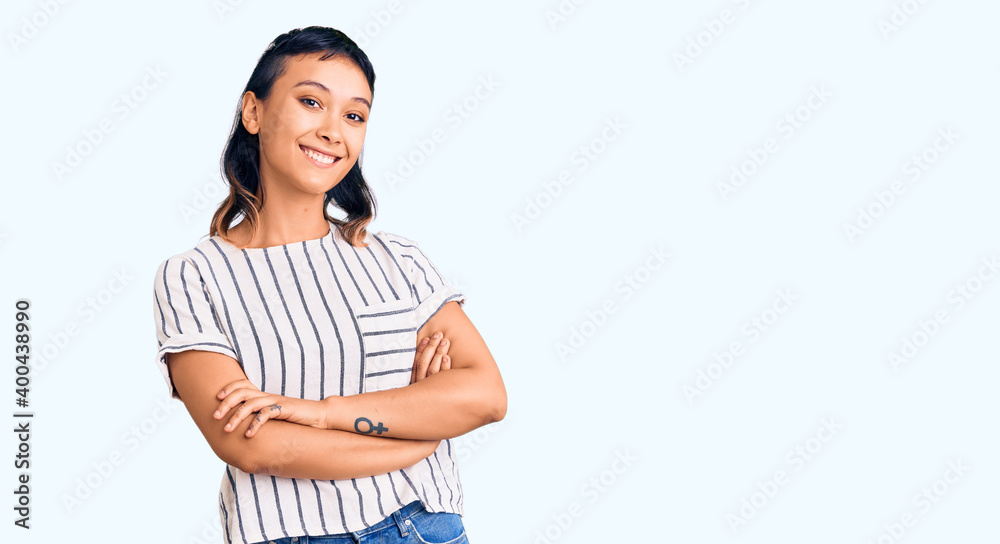 Young woman wearing casual clothes happy face smiling with crossed arms looking at the camera. positive person.