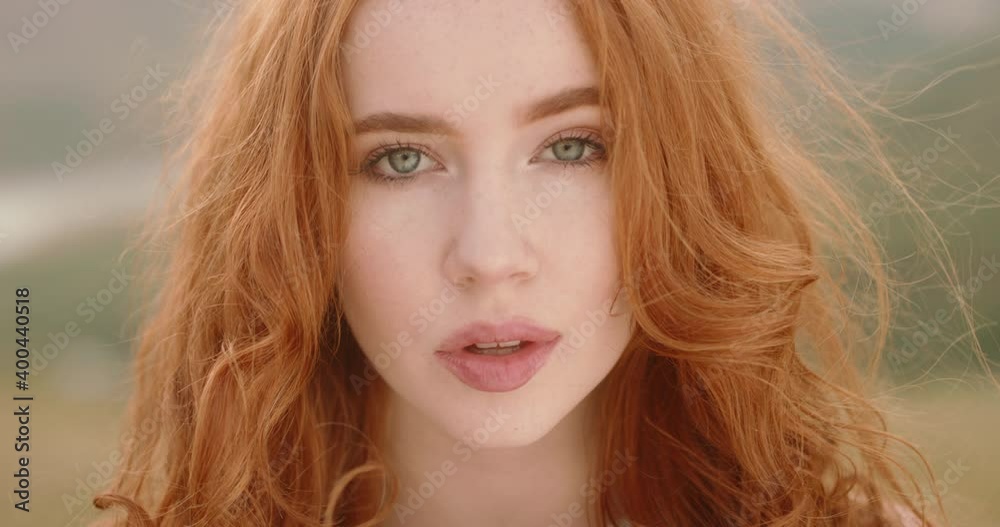 Close up shot of face of beautiful young caucasian girl with red hair ...