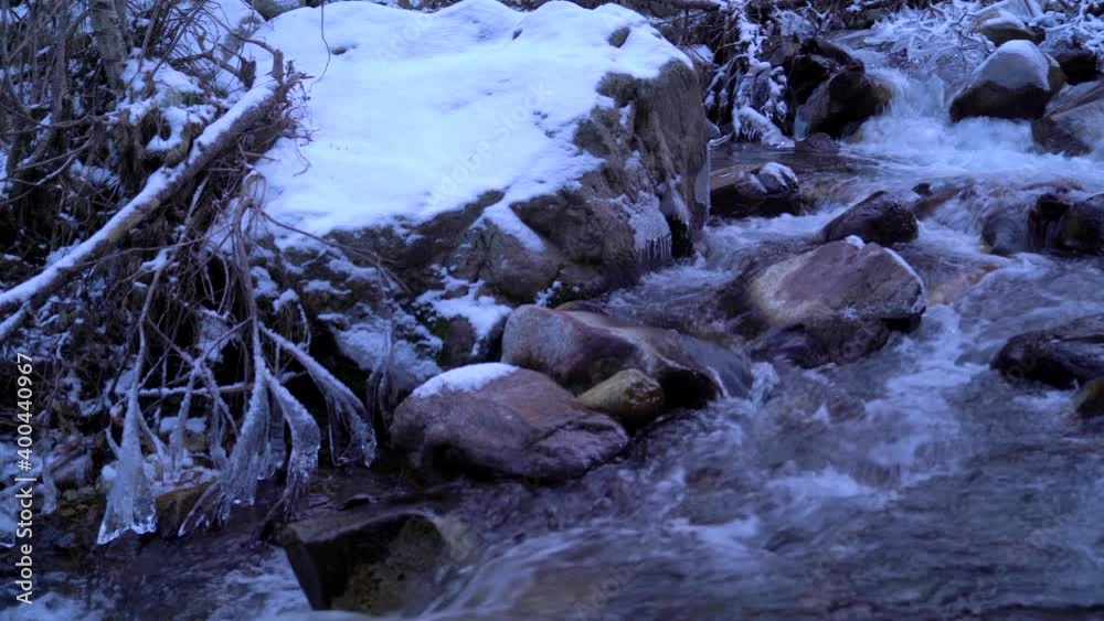 Mountain river with winter white snowy landscape. Winter, cold or Christmas landscape. Beautiful stream with flowing water. Mountain river with winter white snowy landscape. Winter, cold or Christmas landscape. Beautiful stream with flowing water.