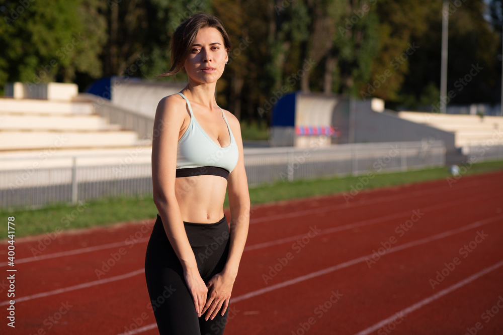 Fit glorious woman posing at the running track