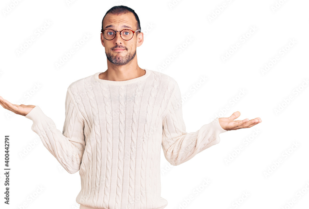 Young handsome man wearing casual clothes and glasses clueless and confused expression with arms and hands raised. doubt concept. Young handsome man wearing casual clothes and glasses clueless and confused expression with arms and hands raised. doubt concept.