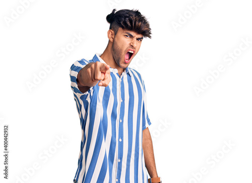 Young hispanic man wearing casual clothes pointing displeased and frustrated to the camera, angry and furious with you