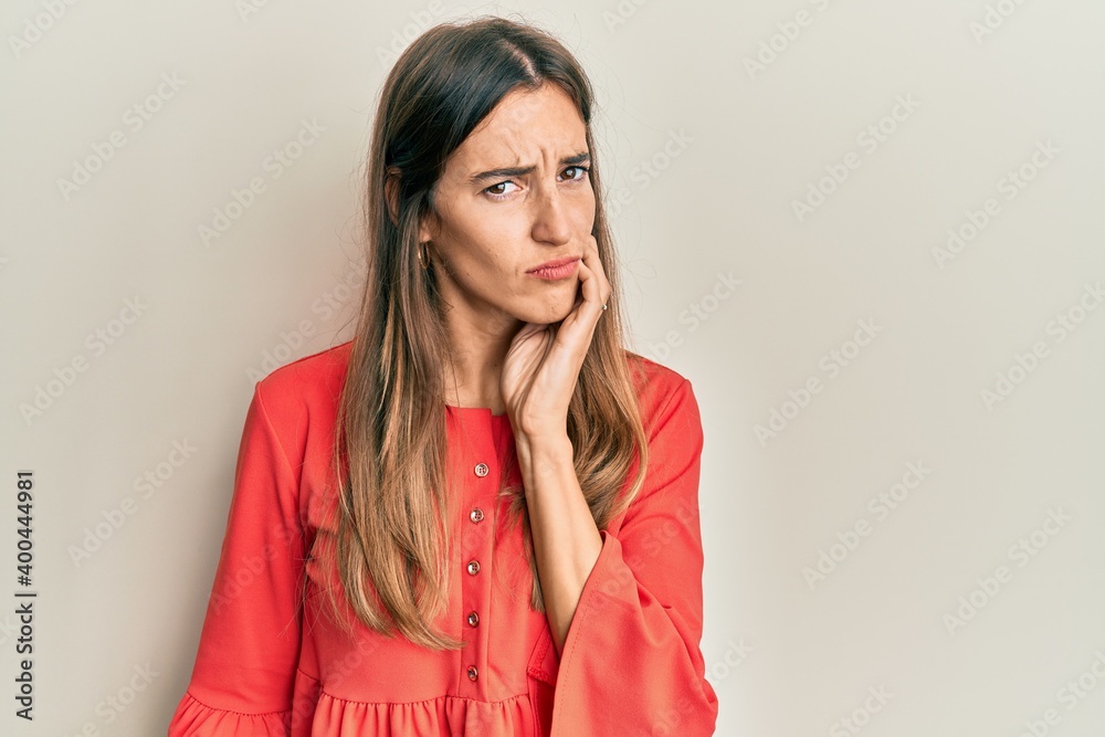 Young beautiful woman wearing casual clothes touching mouth with hand with painful expression because of toothache or dental illness on teeth. dentist Young beautiful woman wearing casual clothes touching mouth with hand with painful expression because of toothache or dental illness on teeth. dentist