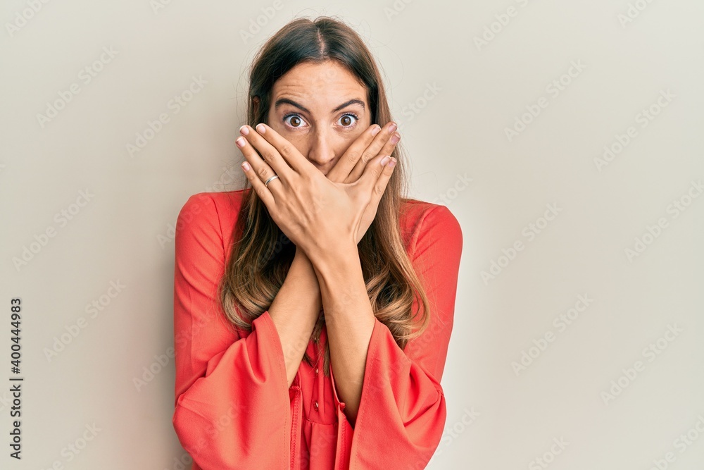 Young beautiful woman wearing casual clothes shocked covering mouth with hands for mistake. secret concept.