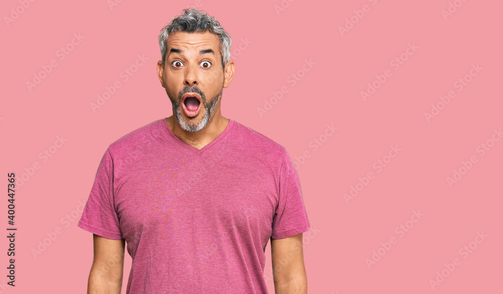 Middle age grey-haired man wearing casual clothes afraid and shocked with surprise and amazed expression, fear and excited face. Middle age grey-haired man wearing casual clothes afraid and shocked with surprise and amazed expression, fear and excited face.