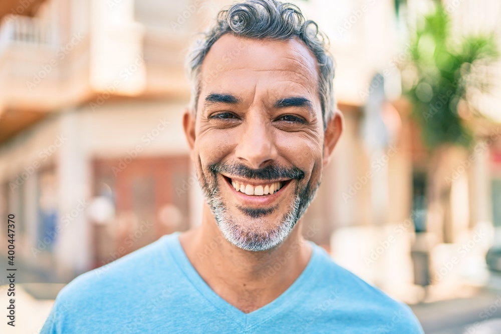 Middle age grey-haired man smiling happy walking at street of city. Middle age grey-haired man smiling happy walking at street of city.
