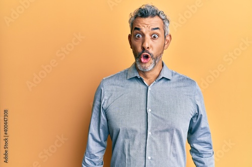 Middle age grey-haired man wearing casual clothes scared and amazed with open mouth for surprise, disbelief face