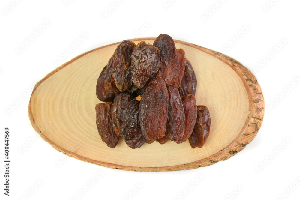 Natural dried dates (fruits of date palm Phoenix dactylifera) on wood. isolated on white background Natural dried dates (fruits of date palm Phoenix dactylifera) on wood. isolated on white background