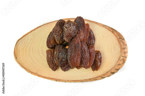 Natural dried dates (fruits of date palm Phoenix dactylifera) on wood. isolated on white background