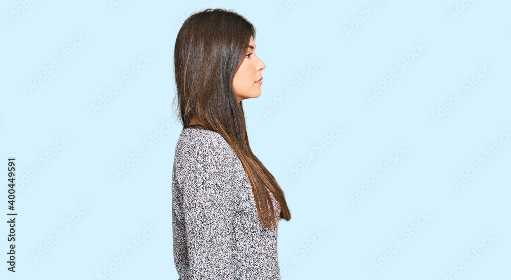 Young brunette woman wearing casual winter sweater looking to side, relax profile pose with natural face with confident smile. Young brunette woman wearing casual winter sweater looking to side, relax profile pose with natural face with confident smile.