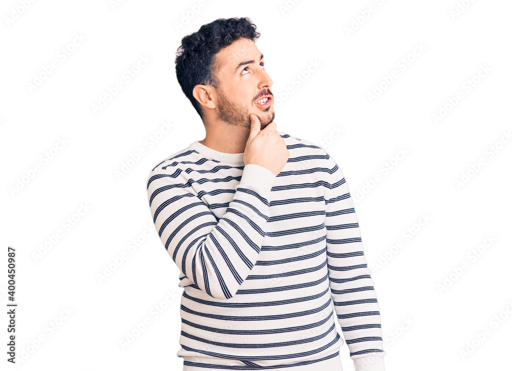 Young hispanic man wearing casual clothes thinking worried about a question, concerned and nervous with hand on chin Young hispanic man wearing casual clothes thinking worried about a question, concerned and nervous with hand on chin
