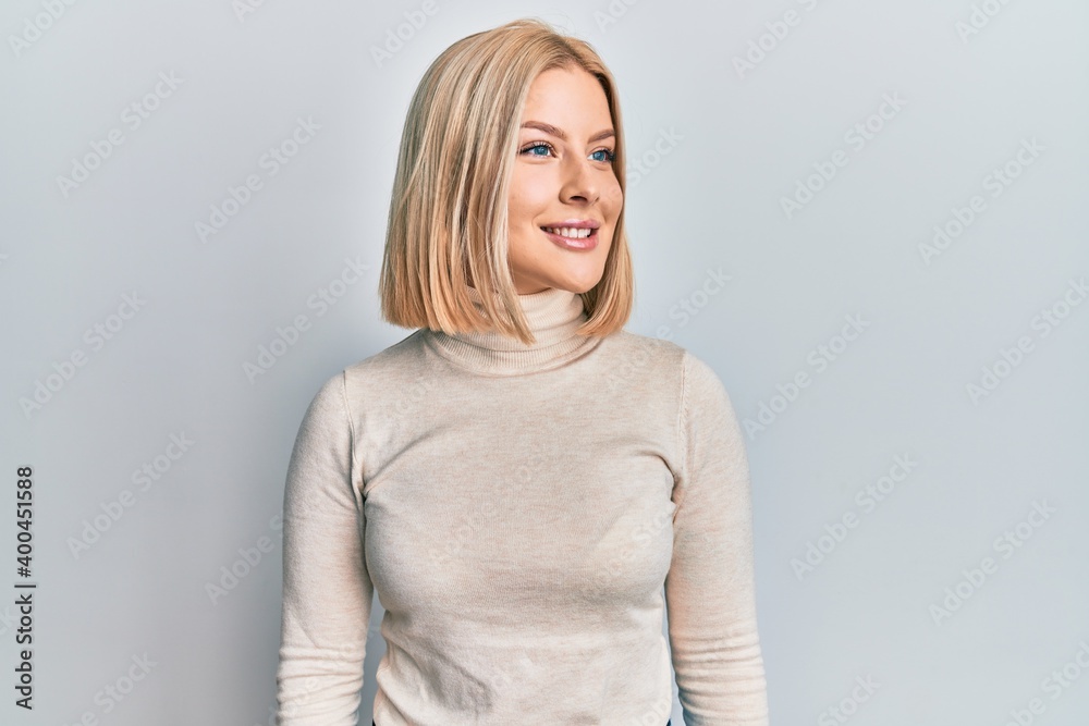 Young blonde woman wearing casual clothes looking to side, relax profile pose with natural face and confident smile. Young blonde woman wearing casual clothes looking to side, relax profile pose with natural face and confident smile.