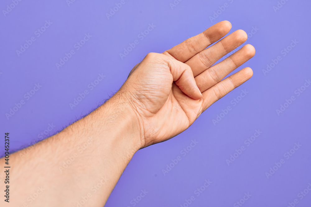 Hand of caucasian young man showing fingers over isolated purple background counting number 4 showing four fingers