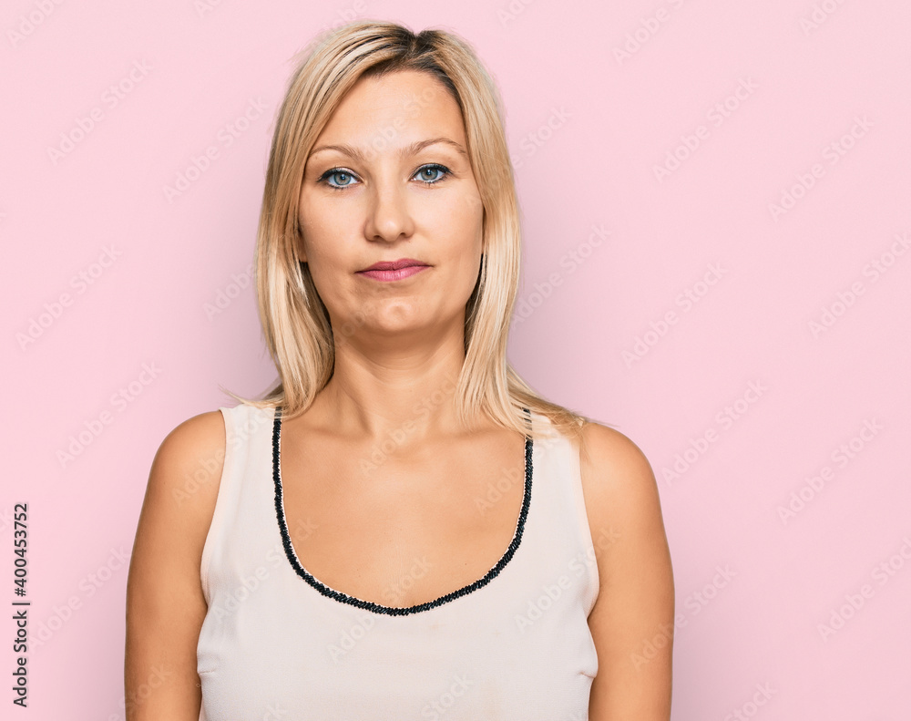 Middle age caucasian woman wearing casual clothes relaxed with serious expression on face. simple and natural looking at the camera.