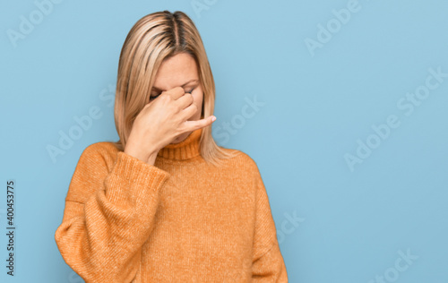 Middle age caucasian woman wearing casual winter sweater tired rubbing nose and eyes feeling fatigue and headache. stress and frustration concept.