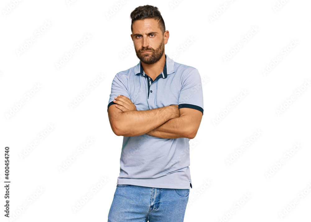 Handsome man with beard wearing casual clothes skeptic and nervous, disapproving expression on face with crossed arms. negative person. Handsome man with beard wearing casual clothes skeptic and nervous, disapproving expression on face with crossed arms. negative person.