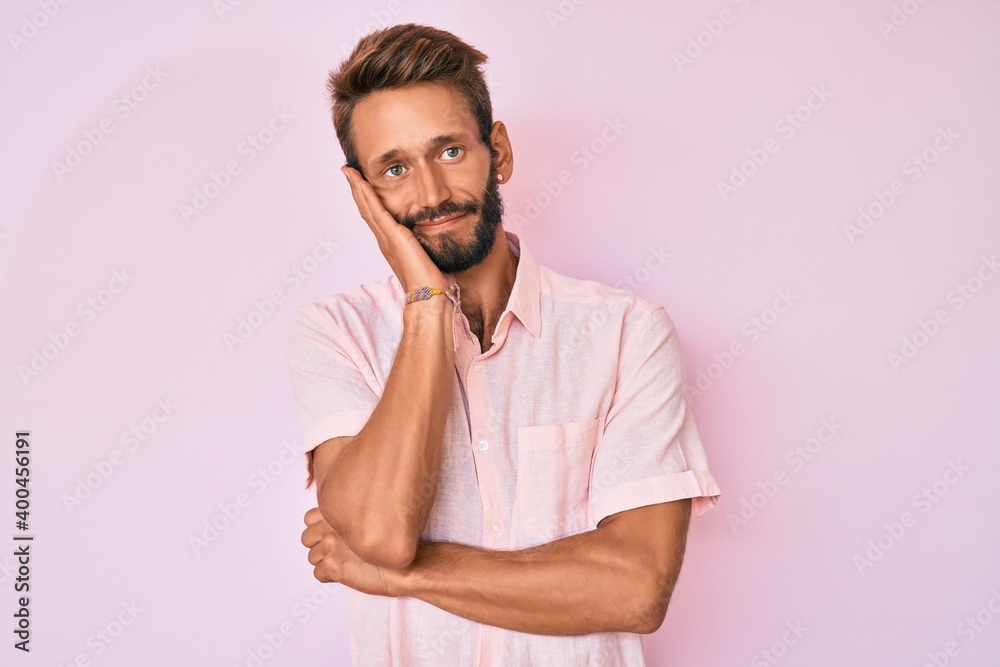 Handsome caucasian man with beard wearing casual pink shirt thinking looking tired and bored with depression problems with crossed arms. Handsome caucasian man with beard wearing casual pink shirt thinking looking tired and bored with depression problems with crossed arms.