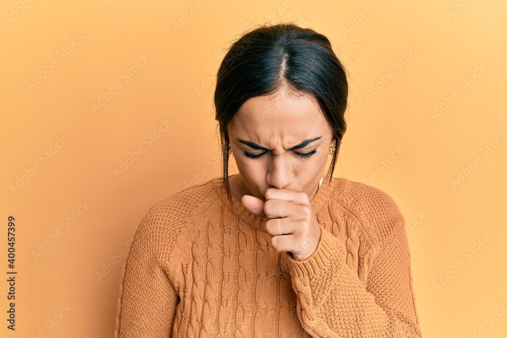 Young brunette woman wearing casual winter sweater feeling unwell and coughing as symptom for cold or bronchitis. health care concept. Young brunette woman wearing casual winter sweater feeling unwell and coughing as symptom for cold or bronchitis. health care concept.