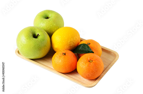 Fruit on a wooden tray. Apples, tangerines and lemon isolated on a white background.