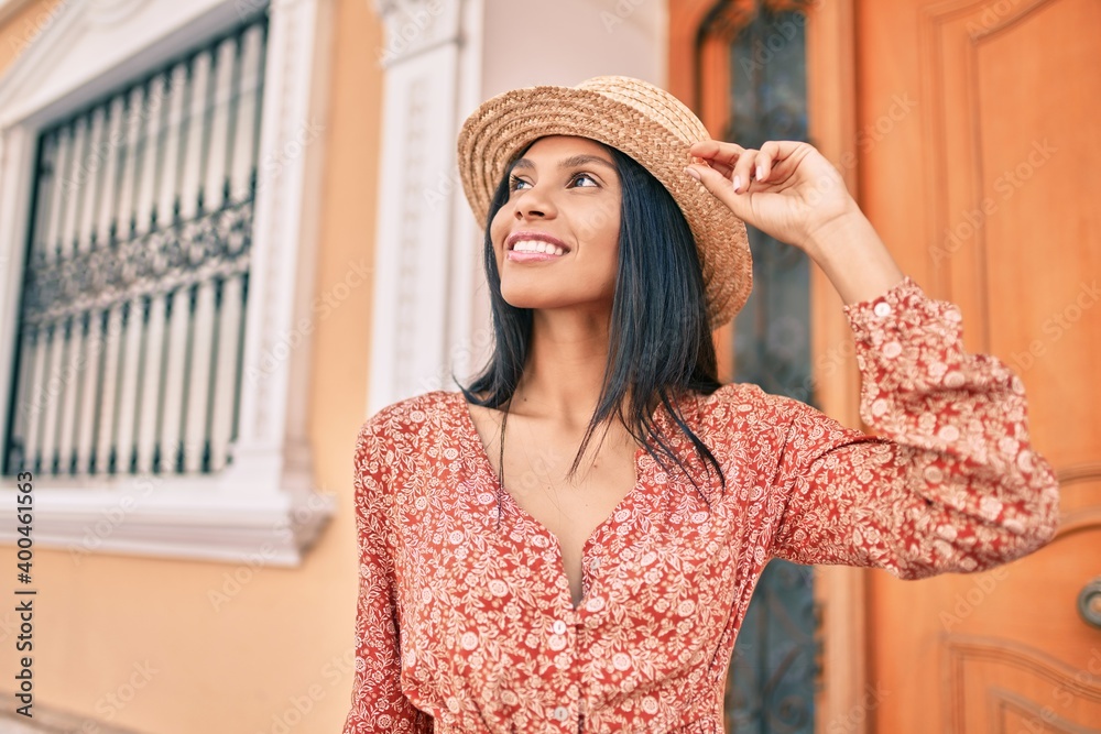 Young african american tourist woman on vacation smiling happy walking at the city.