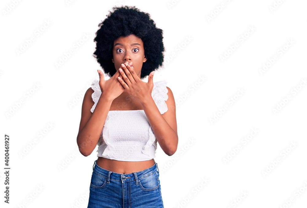 Young african american woman wearing casual clothes shocked covering mouth with hands for mistake. secret concept. Young african american woman wearing casual clothes shocked covering mouth with hands for mistake. secret concept.